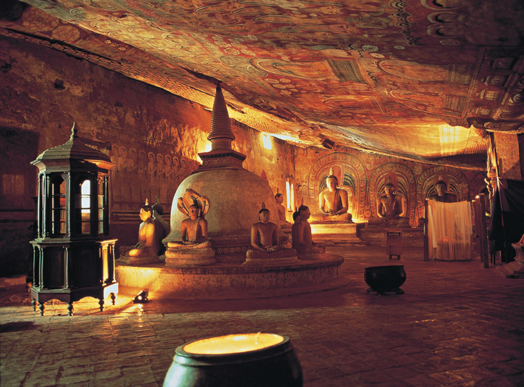 At the Dambulla Cave Temple, in Sigiriya, Sri Lanka, hundreds of gilded Buddhist statues, some 50 feet long, sit, stand, and lie beneath 21,000 square feet of tapestry-like cave paintings depicting Buddha and his life. 